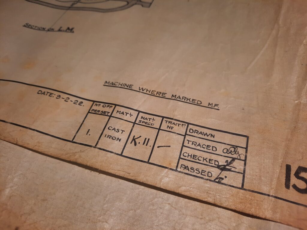 Zoomed in image of an engineering drawing detail showing dates and signatures of drafters