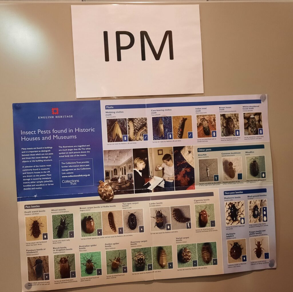 Image shows a wall with 'IPM' on it and an English Heritage chart depicting different types of pests, like beetles and moths, and also non-pests.