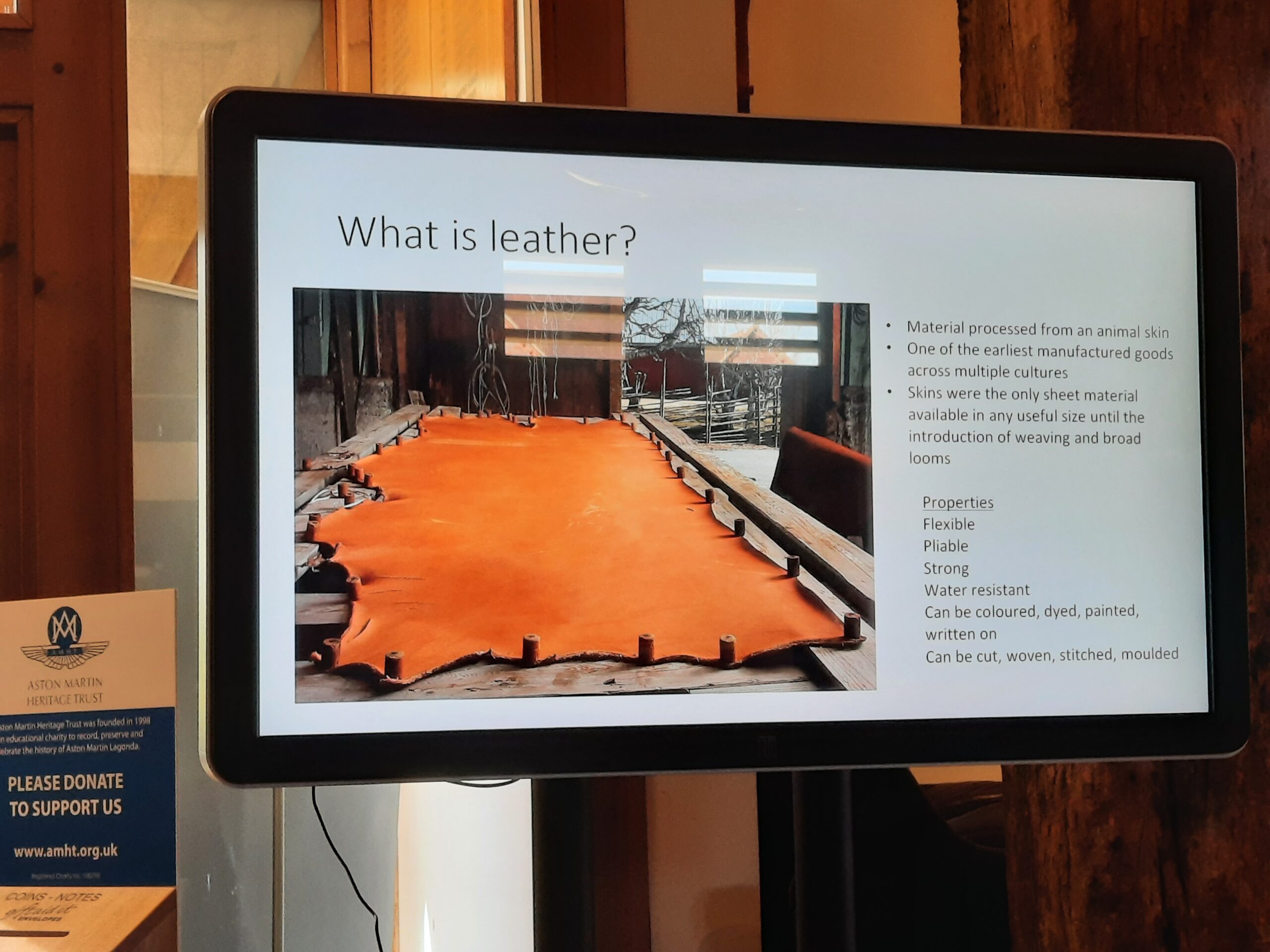Presentation slide showing an image of a cows hide stretched out and bullet points explaining the properties of leather