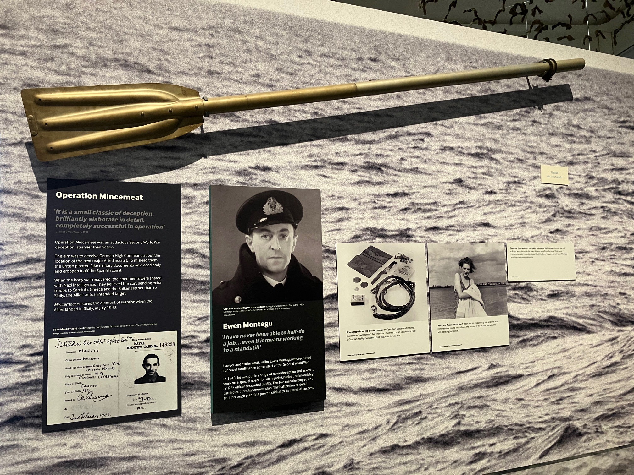 Image of Operation Mincemeat display at the Imperial War Museum, showing information boards about the operation and a paddle from HMS Seraph, the British submarine that transported the body of 'Major Martin'