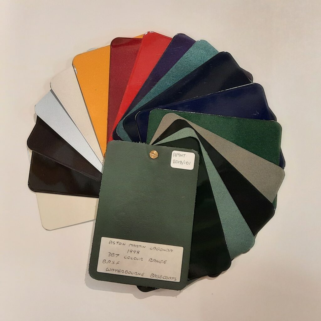 Aerial view of DB7 Paint Samples fanned out into a circle. Includes 17 samples ranging from green, blue and red to gold and silver