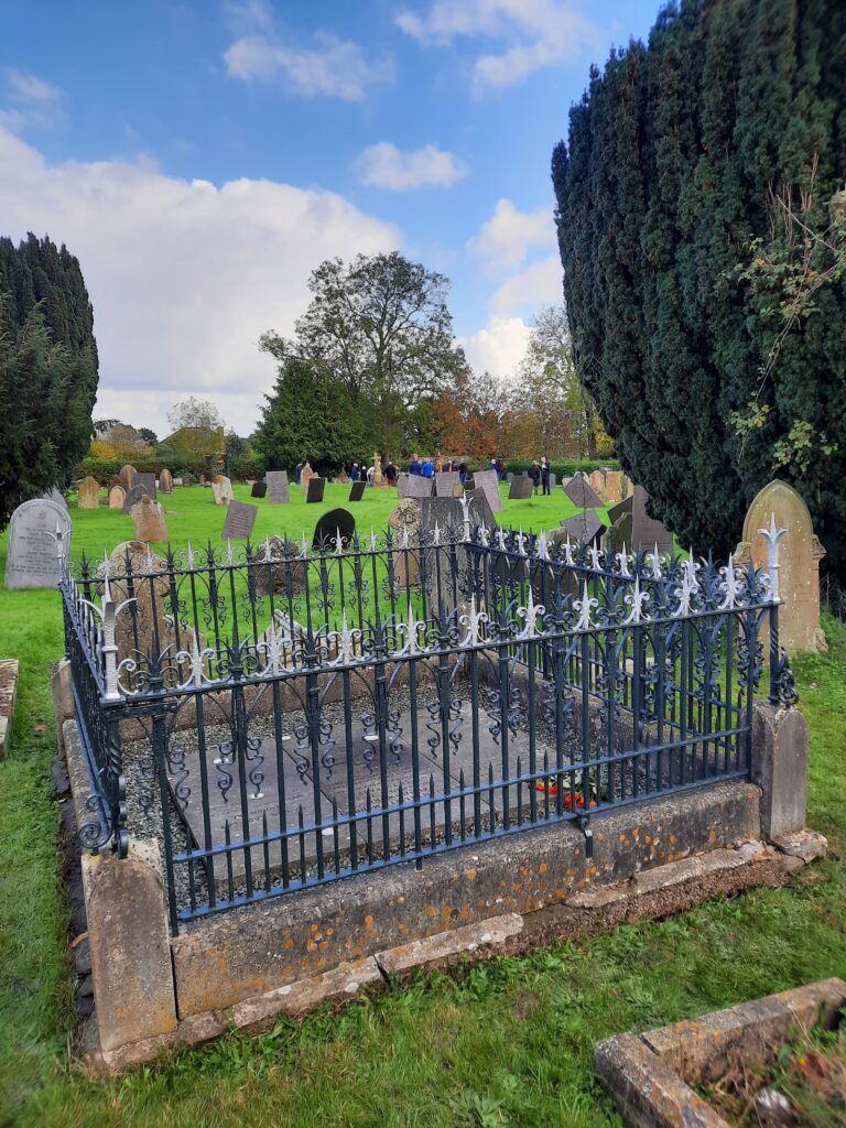 Colour image of the graves of Louis Zborowski, his parents and brother with St James Church yard in the background